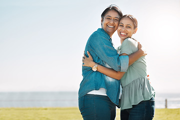 Image showing Love, mother and outdoor adult daughter have hug happy, smile and bonding on vacation, adventure or holiday to embrace, beach or relax together. Portrait, mom and being cheerful, grateful at seaside.