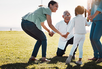Image showing Senior man, child and mother being outdoor, play and have fun while on seaside holiday, vacation and travel in summer. Mama, daughter and on field holding hands in circle, smile and happy together.