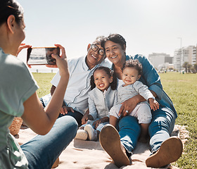 Image showing Grandparents, children and mother with photo on a phone in park together during summer. Relax, happy and smile from kids and senior man and woman with picture on mobile from mom in nature by the sea