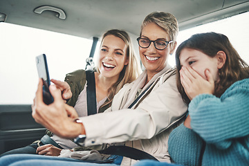 Image showing Family, phone and women taking a selfie in the car on road trip adventure. Grandmother, mom and girl smile for picture on smartphone in backseat for memories of holiday, journey and vacation weekend