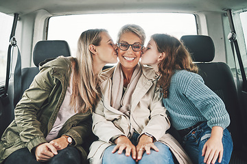 Image showing Family, kiss and road trip with a girl, mother and grandmother in the backseat of a car for a drive. Love, travel and transport with a senior woman, daughter and granddaughter on vacation or holiday