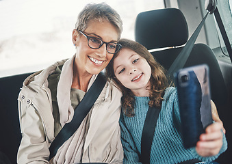 Image showing Grandmother, girl and selfie with phone in a car while on a road trip for social media post online. Senior woman and kid smile, photo and happy with travel holiday with 5g smartphone in Germany