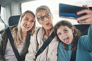 Image showing Phone, selfie and family in a car with silly faces driving to a holiday destination together. Grandmother, mother and girl child taking picture on smartphone on the route to vacation resort in Canada