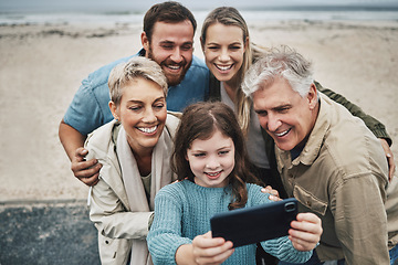 Image showing Family, beach and smile for phone selfie together for quality bonding time, holiday or vacation in the outdoors. Happy parents, grandparents and child smiling for photo on smartphone at the ocean