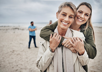 Image showing Mother, daughter and hug, travel at beach and happy bonding during vacation and adventure, love and together in portrait. Women, senior and young, family at seaside and spending quality time.