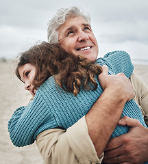 Image showing Family, children and hug with a girl and grandfather embracing on the beach outdoor during a holiday or vacation. Travel, kids and love with a senior man thankful for his granddaughter by the sea