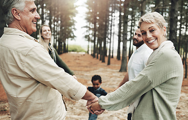 Image showing Diversity, holding hands and family on forest nature walk for bonding, wellness or healthy outdoor holiday. Senior, elderly grandparents portrait for interracial love, care and trust on fun adventure