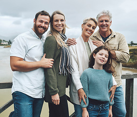 Image showing Family, travel and vacation with a girl, parents and grandparents on holiday or a weekend getaway by a lake. Nature, children and portrait with a happy group of relatives outdoor on the water