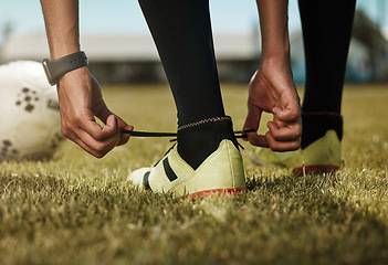 Image showing Shoes tie, sports ball and soccer man or athlete on green grass ready for exercise or training. Fitness, workout and game or match of a sport person player before football cardio in nature and summer