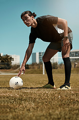 Image showing Man, placing and soccer ball with hand on field for kick, penalty or goal in game, training or match. Sport, football and grass in summer for exercise, fitness and workout in sports for wellness