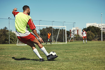 Image showing Soccer, sports and men on a field during a game, training or exercise together. Athlete kicking a football during a professional competition, event or sport with team in a park for fitness in summer