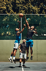 Image showing Sports, start and men jump in basketball training match, cardio exercise and fitness workout on a basketball court. Challenge, healthy and young African players jumping high in game action for a tip