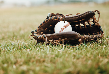 Image showing Baseball, sport and ball with glove on a grass pitch or field outdoor for a competitive game or match. Fitness, sports gear and skill with equipment on the ground for training, practice and game