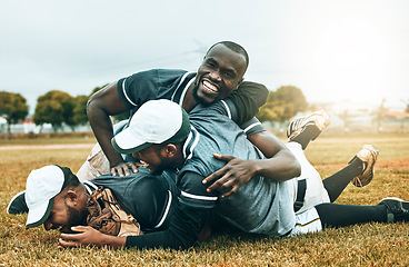 Image showing Winner, team and baseball player success celebration on baseball field by men celebrating on the ground after winning a game. Sports victory, softball and happy group dive on grass at softball field