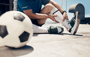 Image showing Football, fitness or man with leg injury while training, exercise or soccer workout on roof of building outdoor. Wellness, health or soccer player with muscle pain, bone emergency or sports accident