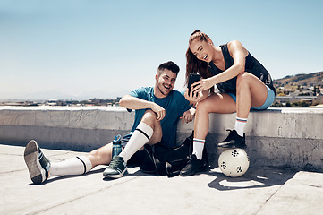 Image showing Soccer training, phone and friends happy on video call or laugh at social media outdoors. Fitness man, athlete woman and relax after lifestyle workout chat on tech communication in city