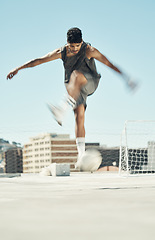 Image showing Soccer, motion and man athlete, fitness and exercise, practice and training for game on outdoor pitch. Young, energy and sports, skill and ball, goal post in urban town and active lifestyle.