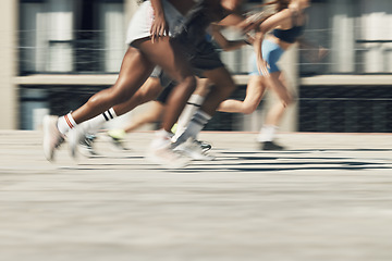 Image showing Running, motion and group of people on path together for marathon race, fitness and speed. Fast run team, urban runner club and racing in city street training workout with feet and legs on ground.