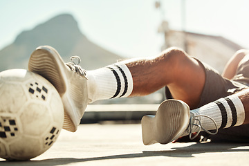 Image showing Soccer, ball and man with slide challenge during match, practice or training on concrete court in the city. Football, fitness and exercise in sports game with athlete legs, shoes and tackle outdoor