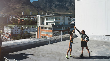 Image showing High five for motivation, women and soccer, fitness and friends in sport training, team exercise routine in cityscape. Athlete with ball celebrate, sports and workout, cardio and endurance in city.