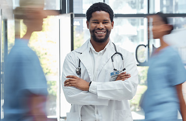 Image showing Medical doctor, man nurse and crossed arms healthcare professional in busy hospital. Portrait, happy face expression and health wellness clinic worker or surgery consultant employee in uniform