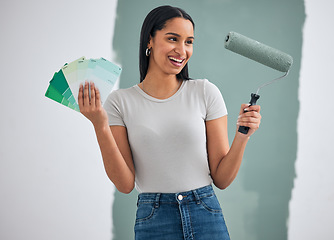 Image showing Interior design, green paint and woman doing home renovation with paintbrush roller and color cards in hand. Decoration, home improvement and creative black woman excited for painting wall and diy