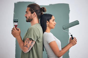 Image showing Paint, renovate and diy with a couple in their home for painting, redecorating or improvement. House, interior and room with a man and woman painting a wall in their apartment for renovation