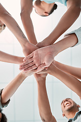 Image showing Hands, collaboration and unity with a business team in a huddle or circle in the office together from below. Meeting, success and motivation with a man and woman group standing in solidarity