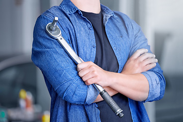 Image showing Mechanic with socket wrench, car maintenance and man in workshop for auto repair and mechanical engineering. Automobile technician arms, transportation engineer and tool, working and f1 industry.