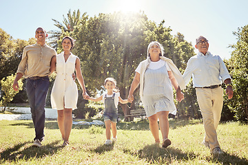 Image showing Black happy family, holding hands and walk in nature park bonding together on summer vacation outdoors. Grandparents, parents and child fun in sun, relationship support and cheerful relax activity.