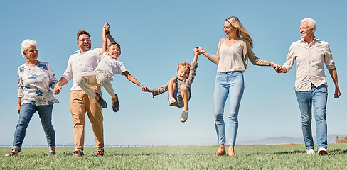 Image showing Lift, happy family and summer walk in a field, play and fun in nature together, smile and laugh. Parents, kids and grandparents love enjoying conversation or family time, smile and hold hands outdoor