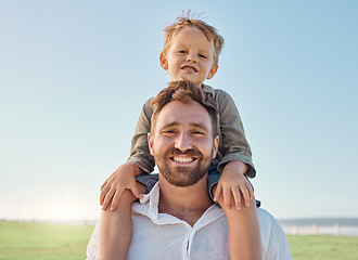 Image showing Family, father and child with smile at nature park for fun, relax and freedom with a blue sky. Portrait of happy man and playful boy kid outdoor for love, piggyback and bonding on a summer vacation