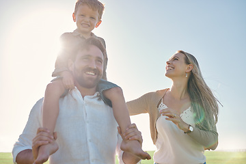 Image showing Family, kids and piggyback with a mother, father and son in the park on a sunny summer day together. Children, love and bonding with a man, woman and boy outdoor on summer vacation or holiday