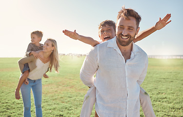 Image showing Family, children and piggyback with parents carrying kids outdoor on a field during summer vacation. Happy, love and holiday with a girl, boy and parents on the back of mom and dad outside for fun