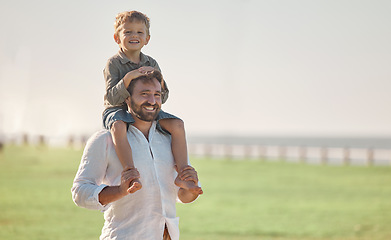Image showing Father, child and summer vacation outdoor in nature for family, love and fun with son on shoulders for happiness portrait. Happy dad man and kid together with smile for time together on grass field