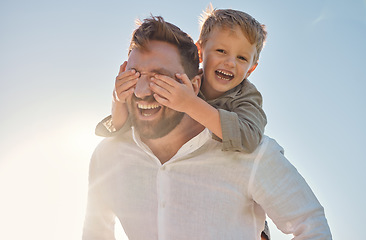 Image showing Dad, child and piggy back with covering eyes for game, playing and funny time in sunshine with love. Sun, sky and family with bonding, father and kid while laughing, comic and happy together outdoor