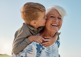 Image showing Kiss, child and grandmother in a park with love, care and freedom for happiness in retirement. Senior, smile and portrait of a woman with hug from a kid and kissing in nature or park with piggyback