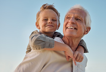 Image showing Piggyback, child and grandfather with smile in nature for freedom, love and relax with a blue sky. Portrait of a young, happy and playful kid being funny, bonding and crazy with a senior man in park