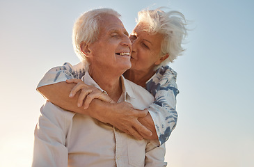 Image showing Kiss, hug and senior couple with love, care and happiness in their marriage together in nature. Happy, relax and smile from an elderly man and woman hugging and kissing for gratitude and commitment