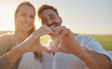 Image showing Heart, hands and couple with smile in a park for love, care and adventure in their marriage together in France. Happy, young and man and woman on date in nature with a loving gesture with hands