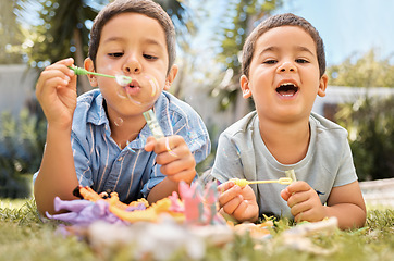 Image showing Brothers kids blowing bubbles in park, garden and backyard, grass and nature fun, joy and happy youth development, growth and relax. Young brothers, happy children playing game and soap bubbles