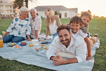 Image showing Picnic, father and children in a park to relax, calm and peace in Australia during summer. Portrait of dad and his kids playing, bonding and on holiday with lunch with grandparents and mom in nature