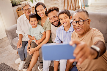 Image showing Selfie, family and phone with grandfather taking a photograph of his grandchildren and their parents at home. Kids, photo and big family smile, happy and social media in living room with smartphone