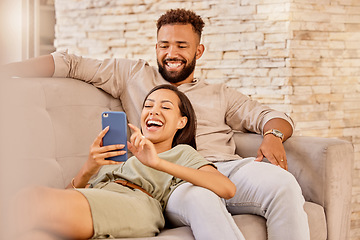 Image showing Couple, laughing and phone funny meme content of happy people laughing on a lounge home couch. Mobile video streaming and social media app scroll of people with wifi technology on a house sofa