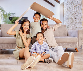 Image showing Family, children and insurance with a mother, father and boy siblings sitting under cardboard in the living room of the home together. Kids, love and cover with a boy, brother and parents in a house