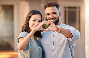 Image showing Love, hand and heart with couple in front of house, family and real estate by young homeowner. Hands, happy family and heart shape sign by woman and man buying, moving and excited about relocating