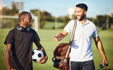 Image showing Soccer players, friends and men walking on football field after practice or fitness training on grass field. Diversity, smile and football players talking, bonding or discussion after sports workout.