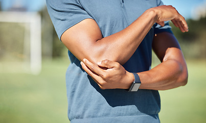 Image showing Sports man with elbow pain on arm, injury in outdoor soccer field. Hand massage bone, person with emergency muscle problem, physiotherapy in sport and joint accident with physical therapy