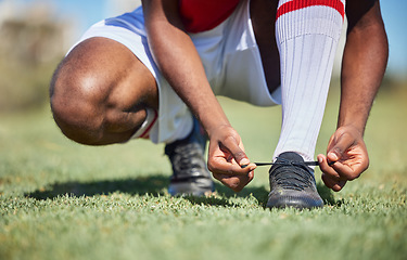 Image showing Man tie football shoes lace on soccer field, athlete ready for sports training in Portugal and exercise on grass stadium. Young person in uniform on pitch, prepare for game and socks with boots