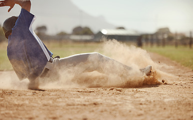 Image showing Baseball, baseball player running and diving for home plate in dirt during sport ball game competition on sand of baseball pitch. Sports man, ground slide and summer fitness training at Dallas Texas